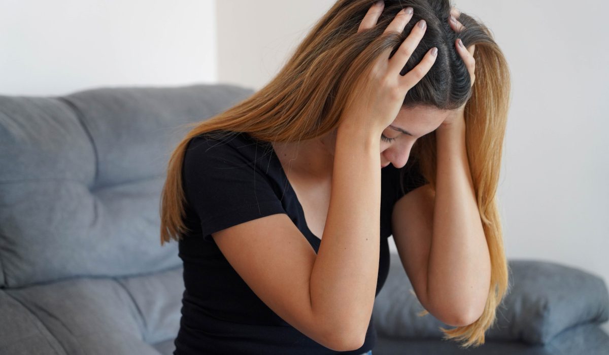 Desperate frustrated woman suffering from depression. Sad girl alone at home. Mental health, anxiety depressive thoughts.