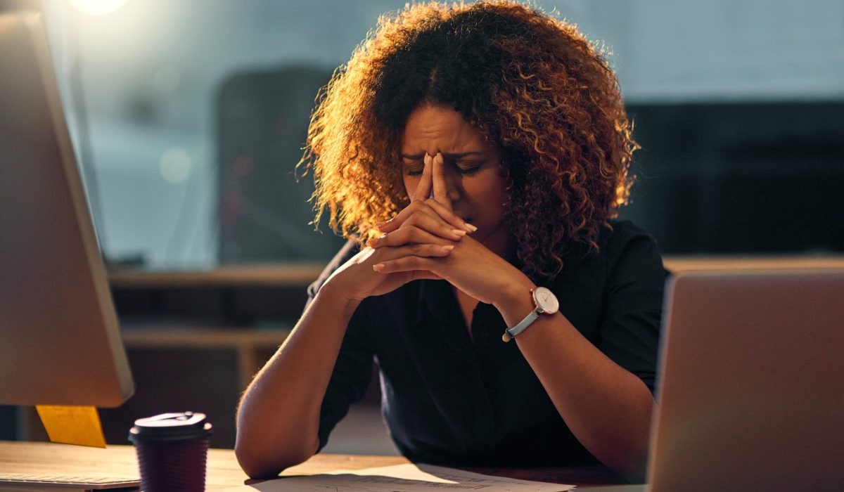 Stressed out, black businesswoman and working late night on laptop for work deadline with problem. Corporate, content writer and office with upset person, mental health issues and worrying in company.